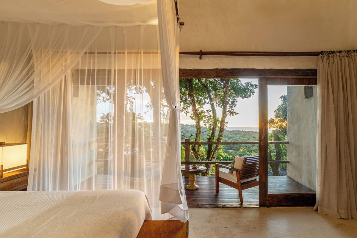 deluxe duplex, bathtub, poolside | balcony view