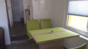 A small dining area with a table and four chairs.