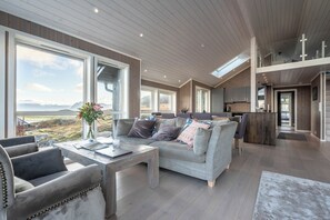 Deluxe House, 3 Bedrooms, Ocean View | Living area | Flat-screen TV, heated floors - Lofoten Links Lodges (Vagan)