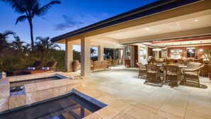 A spacious outdoor patio with a hot tub, lounge chairs, and a dining area with wicker furniture. - Oceanview Mauna Kea Luxury Villa - Private Pool & Spa - In-home Chefs Available (Waimea)
