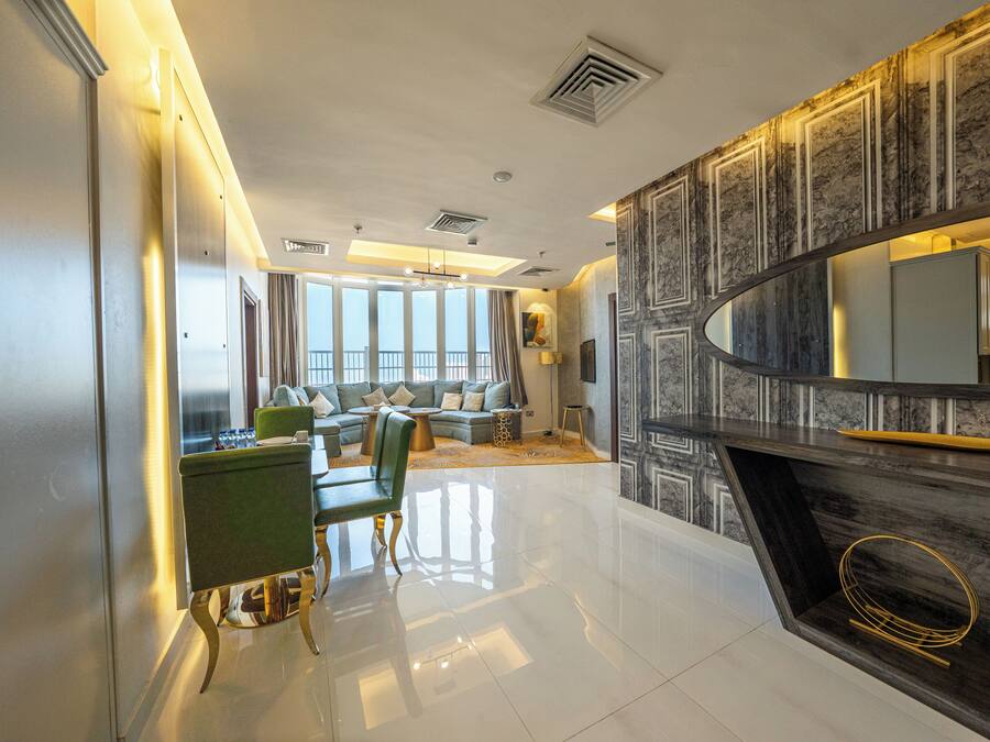 A modern living room with a fireplace, a sofa set, and a dining area.