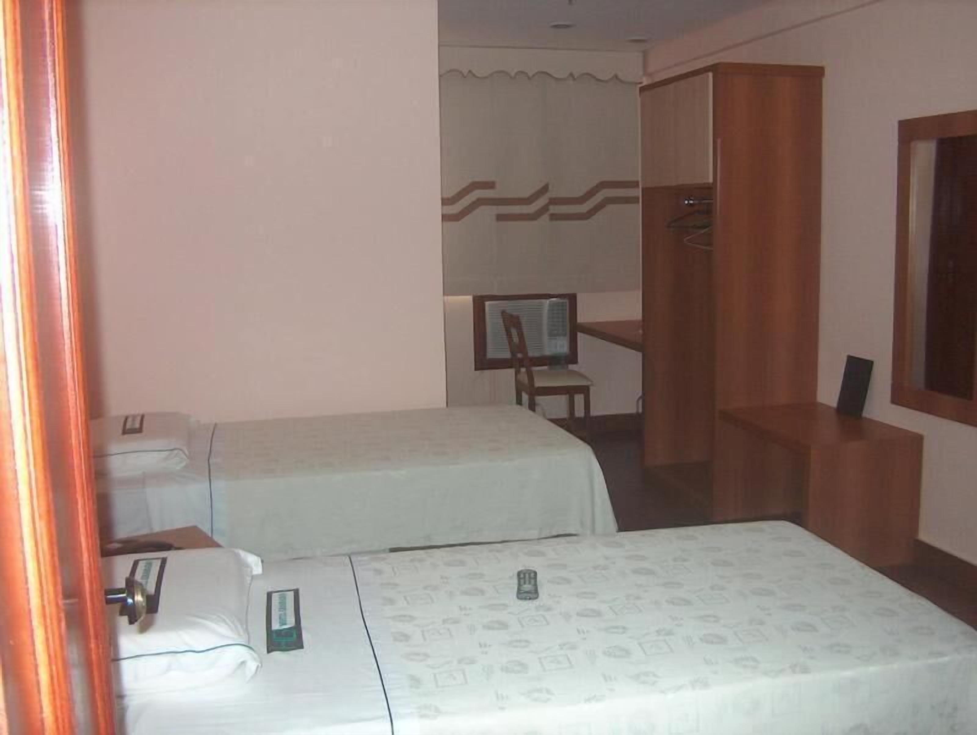 minibar, desk, blackout curtains, iron/ironing board