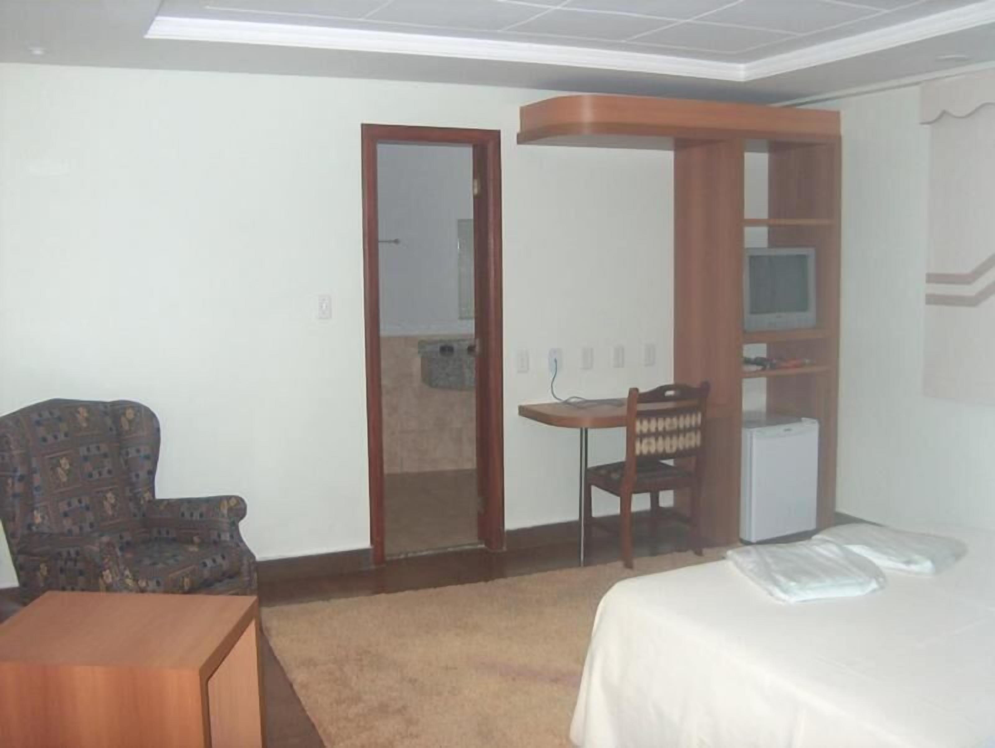 minibar, desk, blackout curtains, iron/ironing board