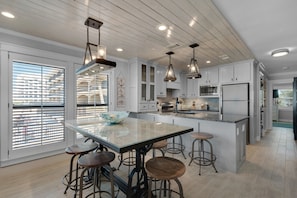 Enjoy cooking in this well-equipped kitchen with a spacious island and stainless steel appliances.