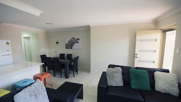 Apartment, 2 Bedrooms | Living area | 55-inch flat-screen TV with digital channels, Smart TV, Netflix