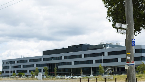 A modern building with multiple floors, a parking lot, and a street sign indicating 'Cale St'. - Midland Haven - Midland WA (Midland)
