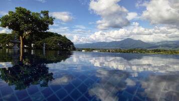 Outdoor pool, open 7 AM to 9 PM, pool loungers