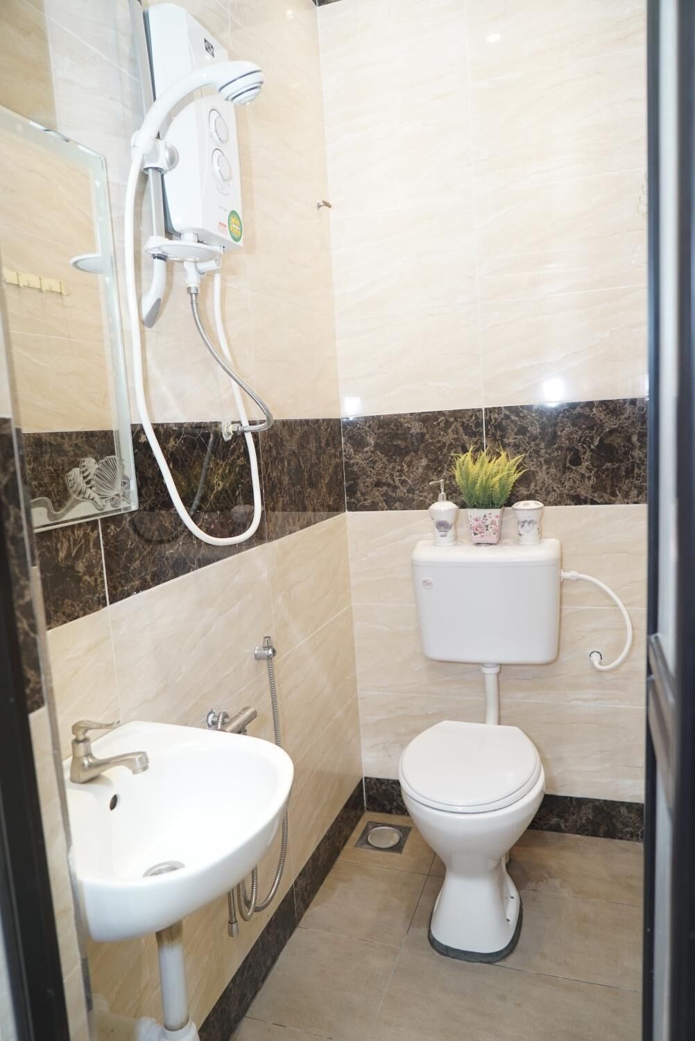 A bathroom with a toilet, sink, and shower.