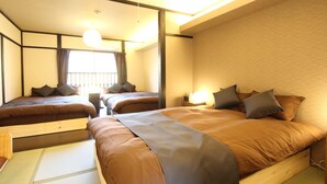 A hotel room with two beds, a window with curtains, a ceiling light, and a wooden floor. - Kyoto Kyo-Tsubaki (Kyoto)