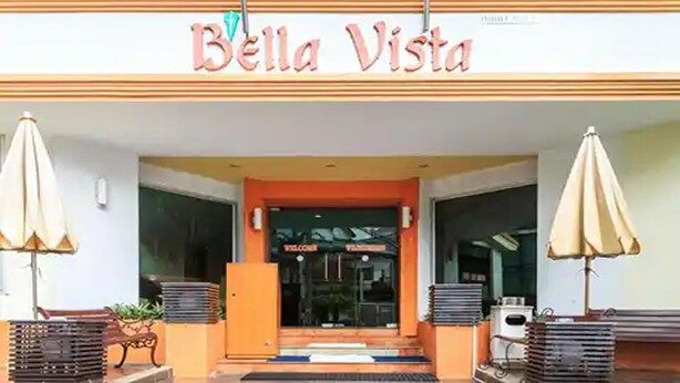 The entrance of Bella Vista with a 'Welcome' sign, outdoor seating, and a tiled floor. - Eastiny Bella Vista Hotel (Pattaya)