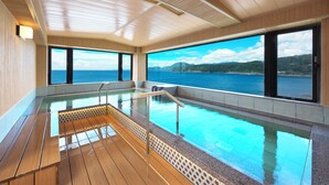 A spacious indoor swimming pool with wooden flooring and a clear view of the sea. - Senoumi (Higashiizu)