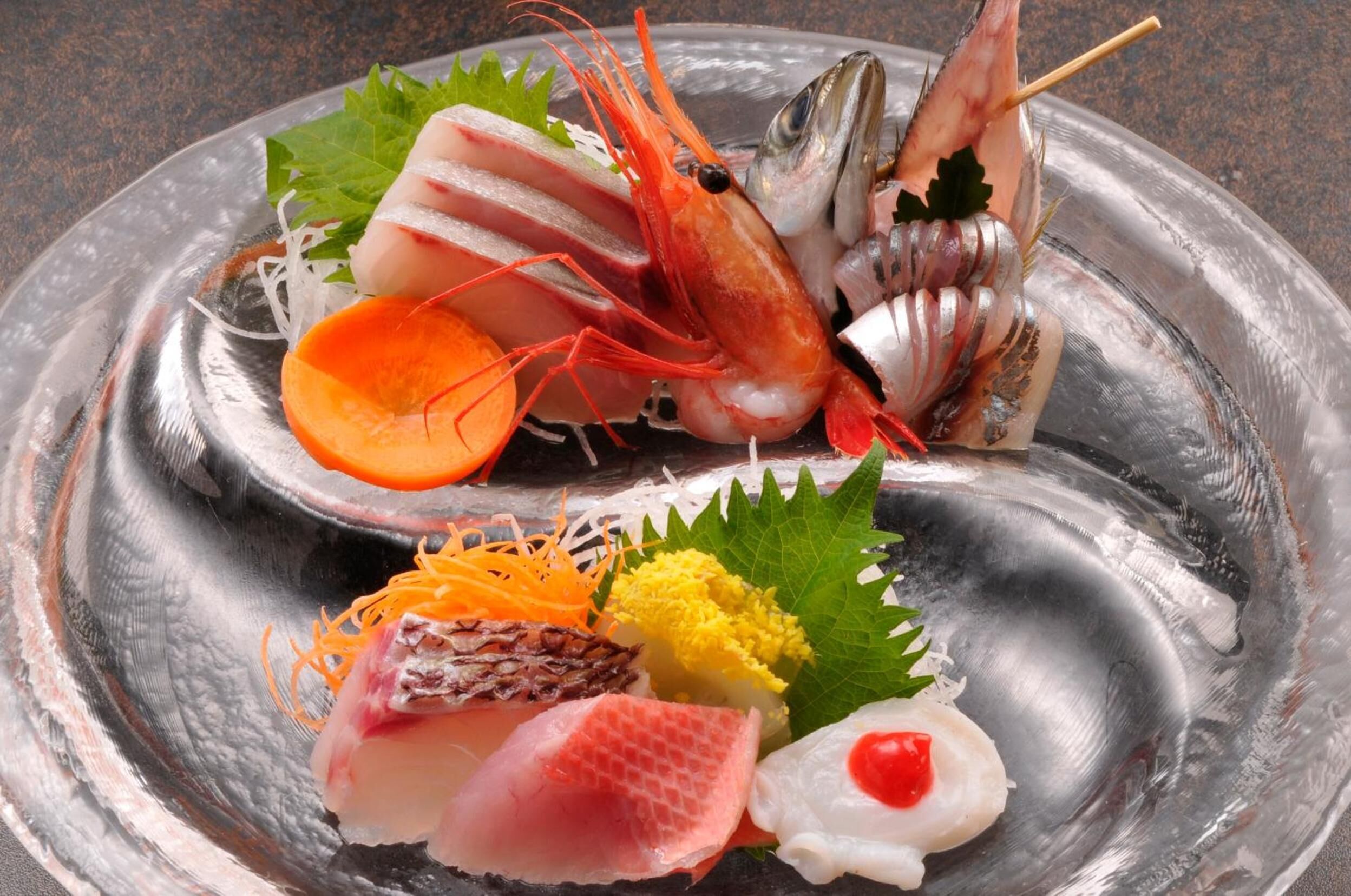 A variety of seafood arranged on a metal plate.