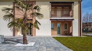A modern two-story building with a flat roof, a balcony, and a well-maintained lawn. - Cimadolmo Prosecco and History (Cimadolmo)