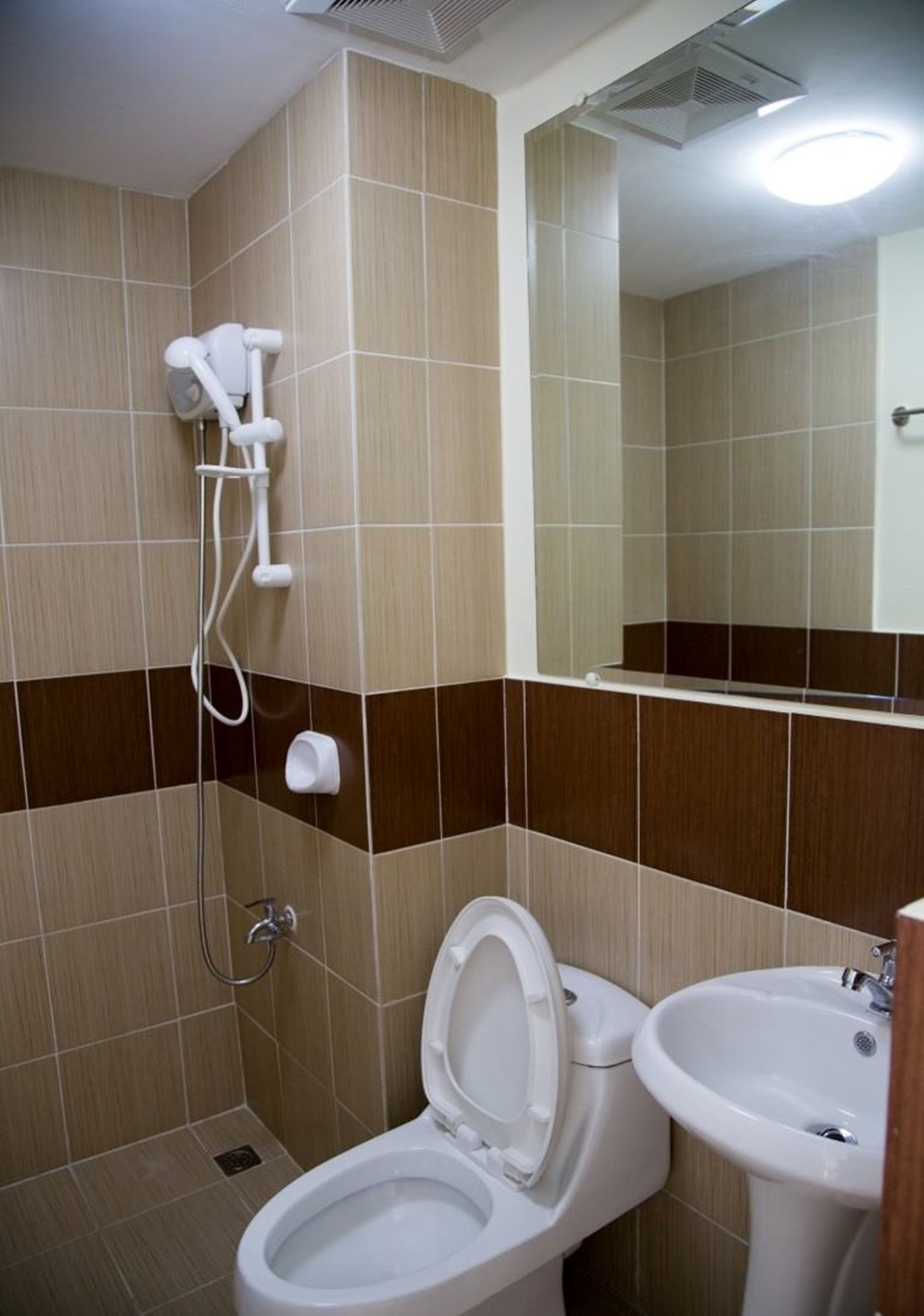 A bathroom with a toilet, bidet, and sink.