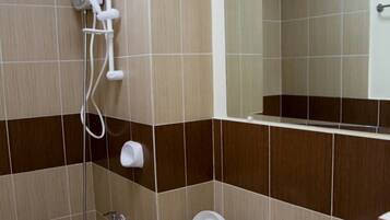 A bathroom with a toilet, bidet, and sink.
