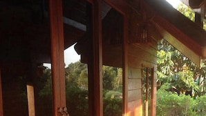 A wooden room with large sliding glass doors leading to a balcony. - Check In & Chill Out Laem Sok Pier (Trat)