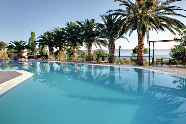 2 outdoor pools, a waterfall pool, open 8 AM to 8 PM, pool umbrellas