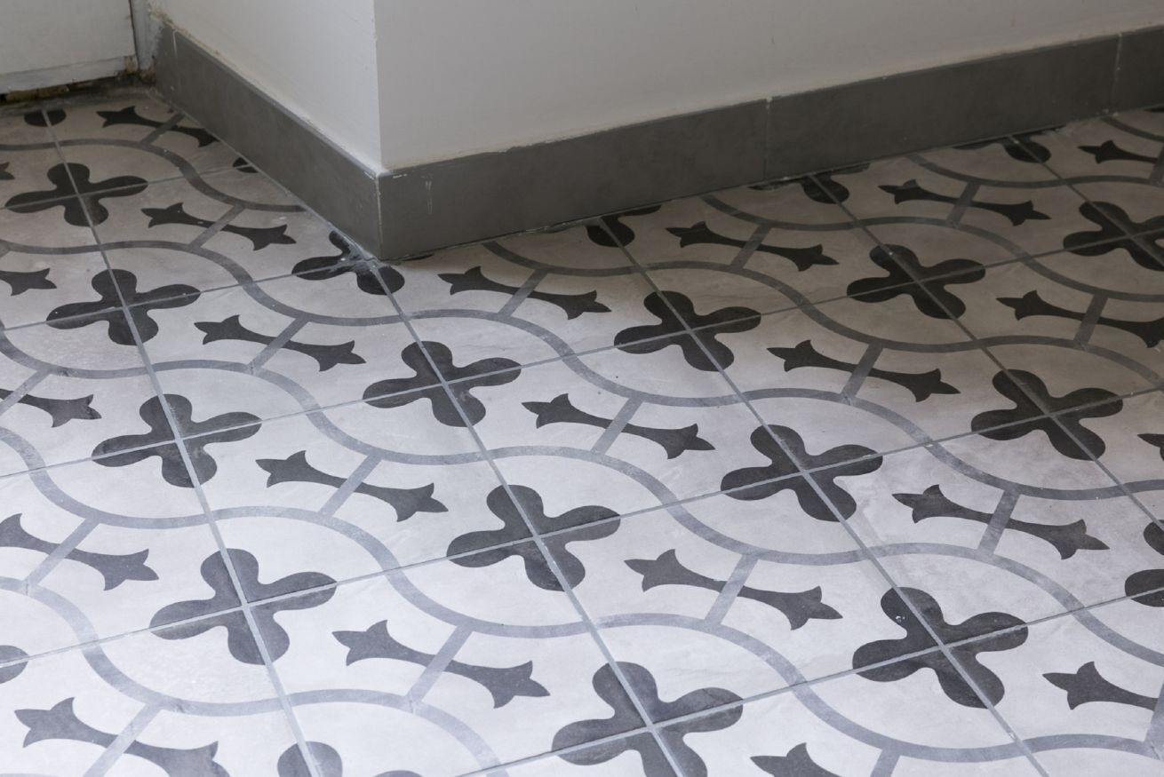 A patterned floor with a cross and circular design.