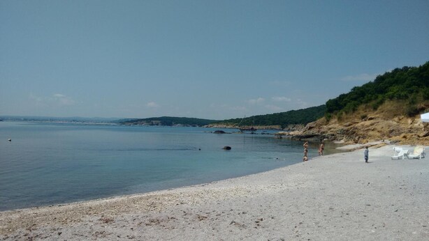 A beach with clear water, a sandy shore, and a few people. - Hotel Lilia 2 (Primorsko)