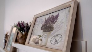 A series of framed artworks on a shelf. - Rebecca's House (Verona)