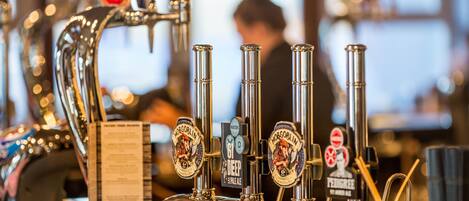 A tap system with multiple spouts and beer labels, including 'Hog's Head' and 'Pedigree'.