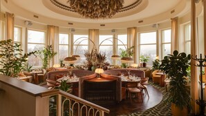 A spacious, elegantly decorated lounge area with multiple seating arrangements, large windows, and a central decorative piece. - Hjortviken Country Club (Hindas)
