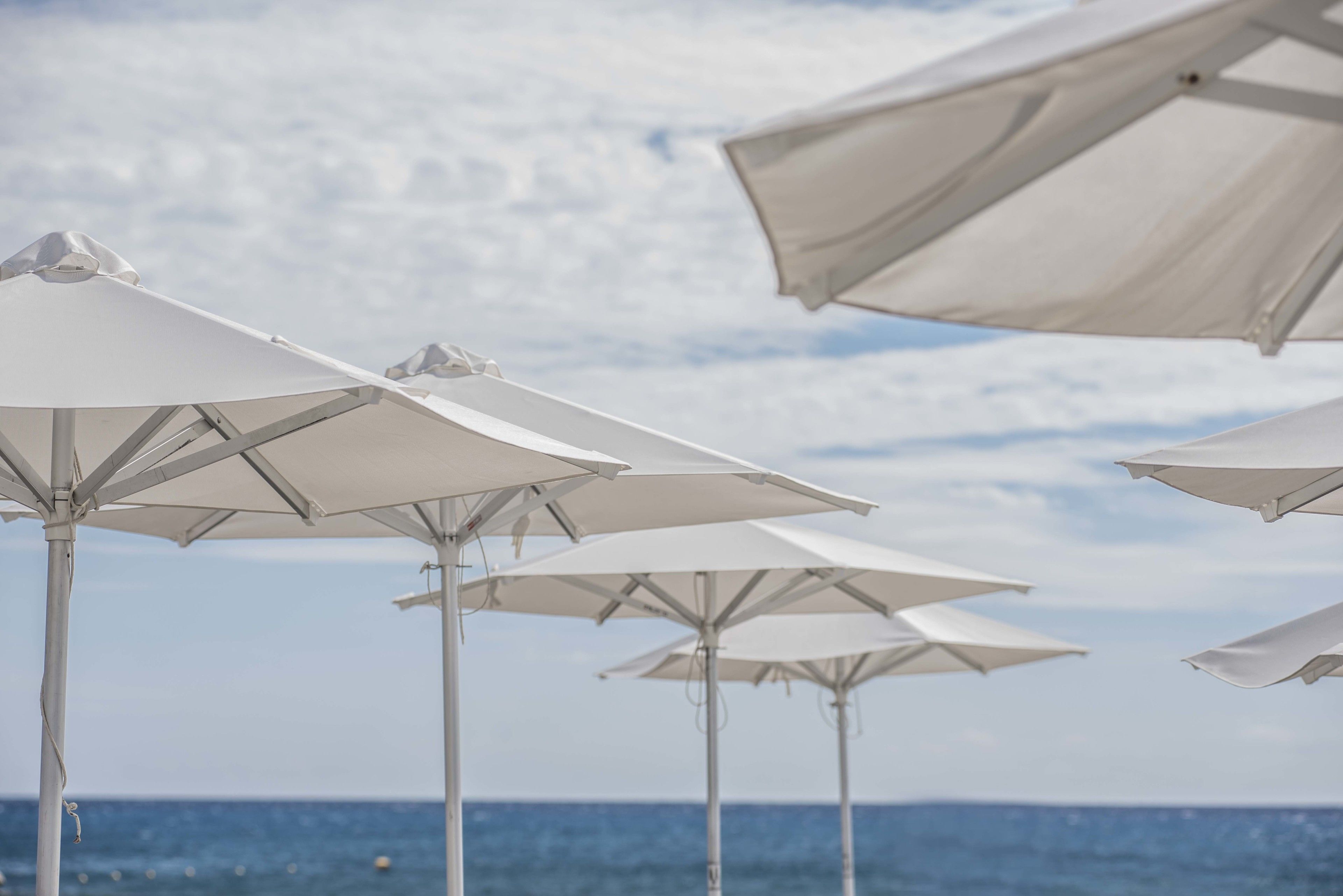 on the beach, beach cabanas, sun-loungers, beach umbrellas
