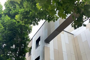A modern building with a flat roof and a facade featuring a mix of beige and gray panels. - University of Essex - Southend Campus  (Southend-on-Sea)