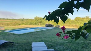 A pool area with lounge chairs and a clear view of the pool.