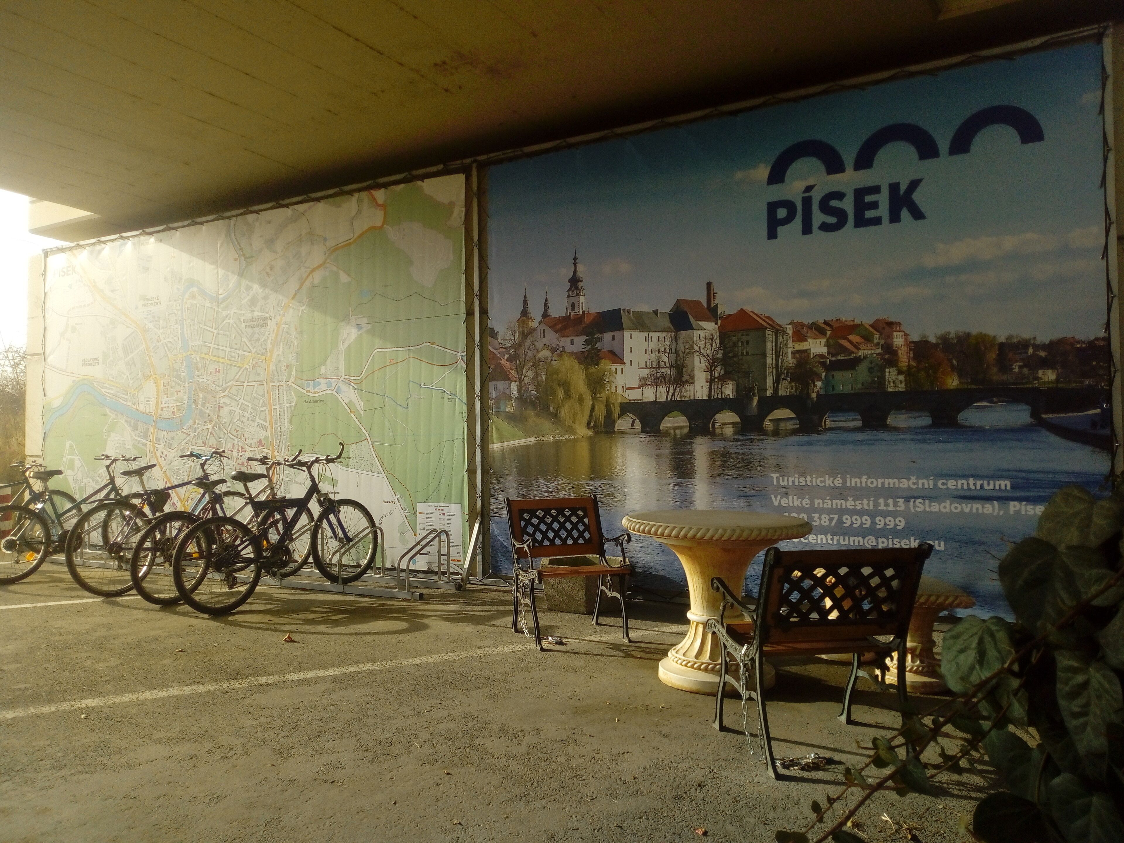 A map and a scenic poster of a cityscape with a river and bridge.
