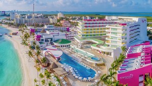A resort with a large pool, beach, and multiple buildings with balconies. - Temptation at The Tower Cancún All Inclusive - Adults Only (Cancun)