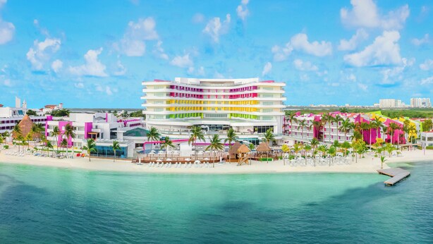 A multi-story hotel with balconies, located on a beach with clear turquoise water. - Temptation at The Tower Cancún All Inclusive - Adults Only (Cancun)