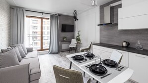 A modern apartment with a dining area, kitchen, and living room. - Good Time Apartment (Warsaw)