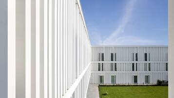 A modern building with a white facade and a flat roof.