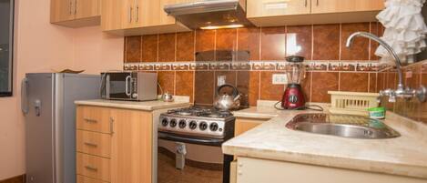 Fridge, microwave, cookware/dishes/utensils, dining tables