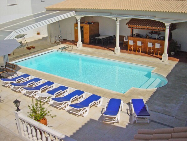 Indoor pool, outdoor pool, open 9 AM to 8 PM, pool umbrellas