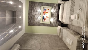 A modern bathroom with a grey and white color scheme, a wooden accent wall, a framed artwork, and a neatly made bed with towels. - Double B Ferruccio I (Rome)