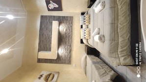 A modern bedroom with a bed, bedside tables, and a small seating area. - Double B Ferruccio I (Rome)