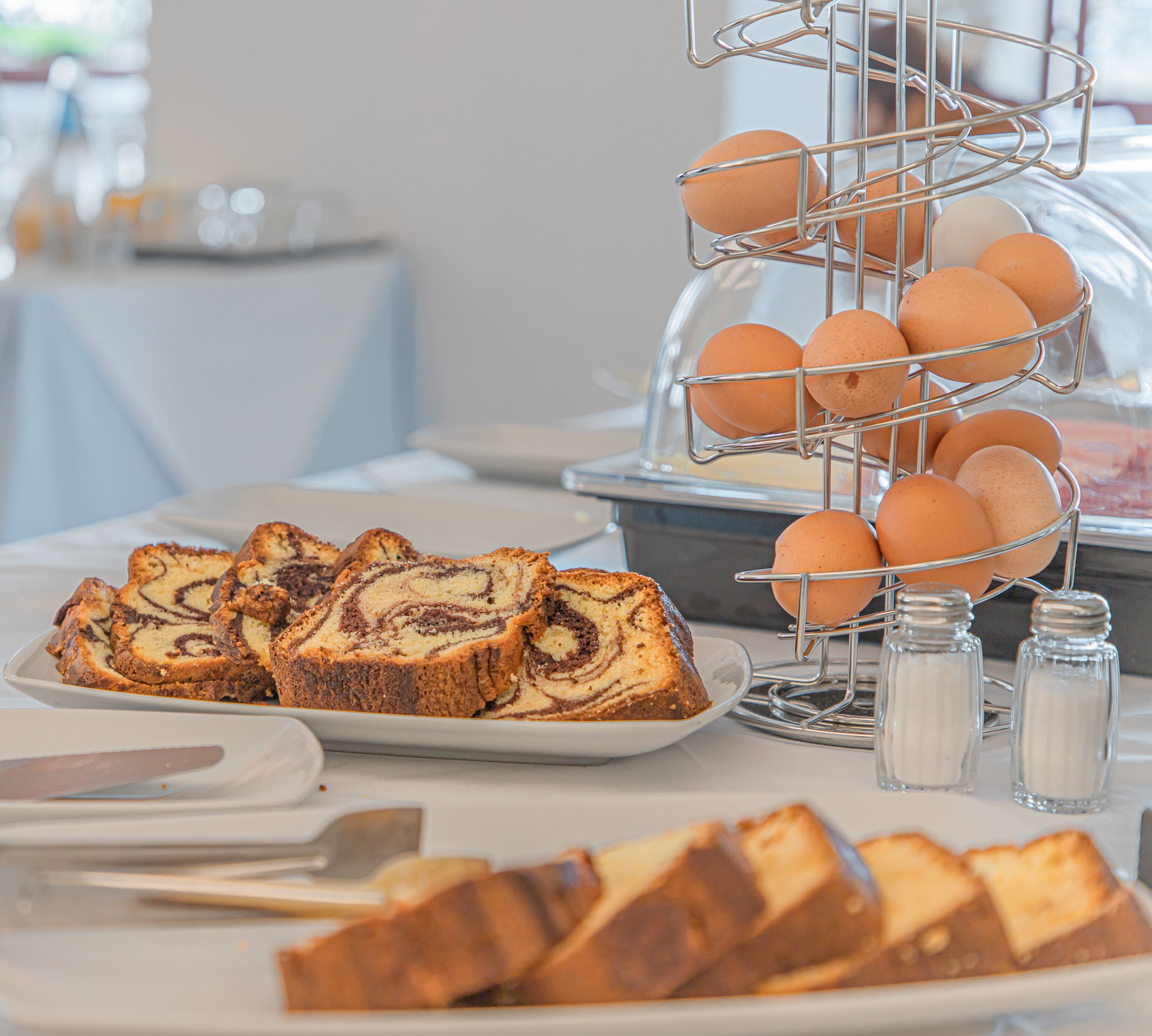A buffet table with sliced bread and eggs.