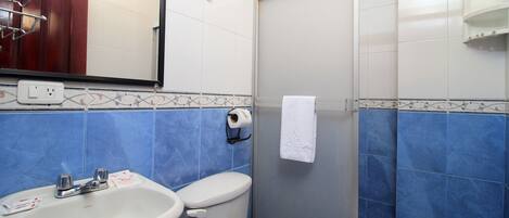 A bathroom with a sink, toilet, and shower.