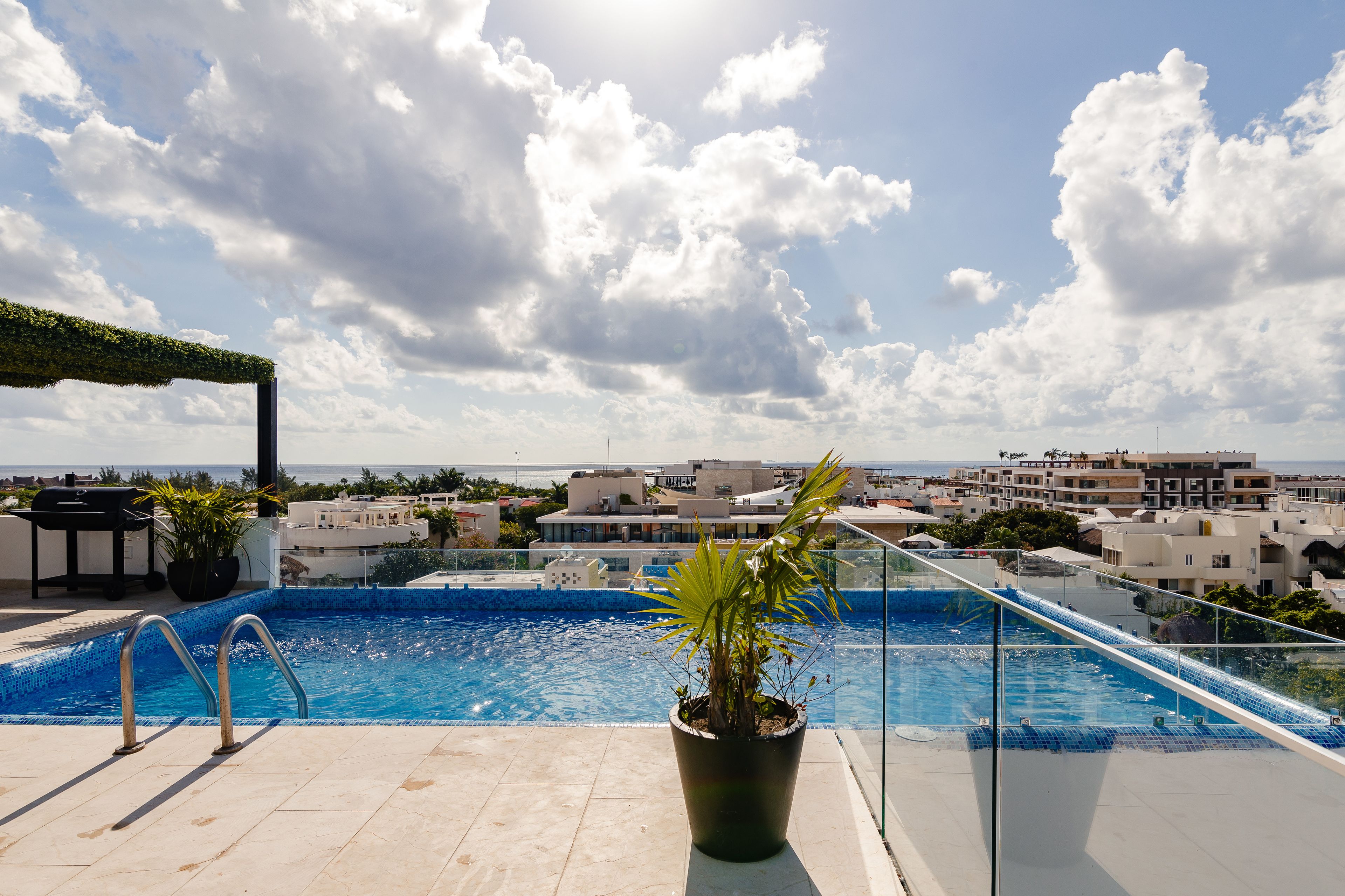 A rooftop pool with a clear view of the cityscape in the background.