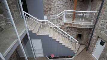 A stone building with a staircase leading to a second floor.