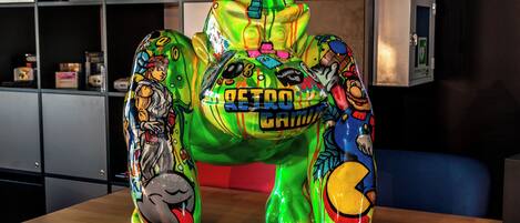 A table with three colorful, cartoonish sculptures.