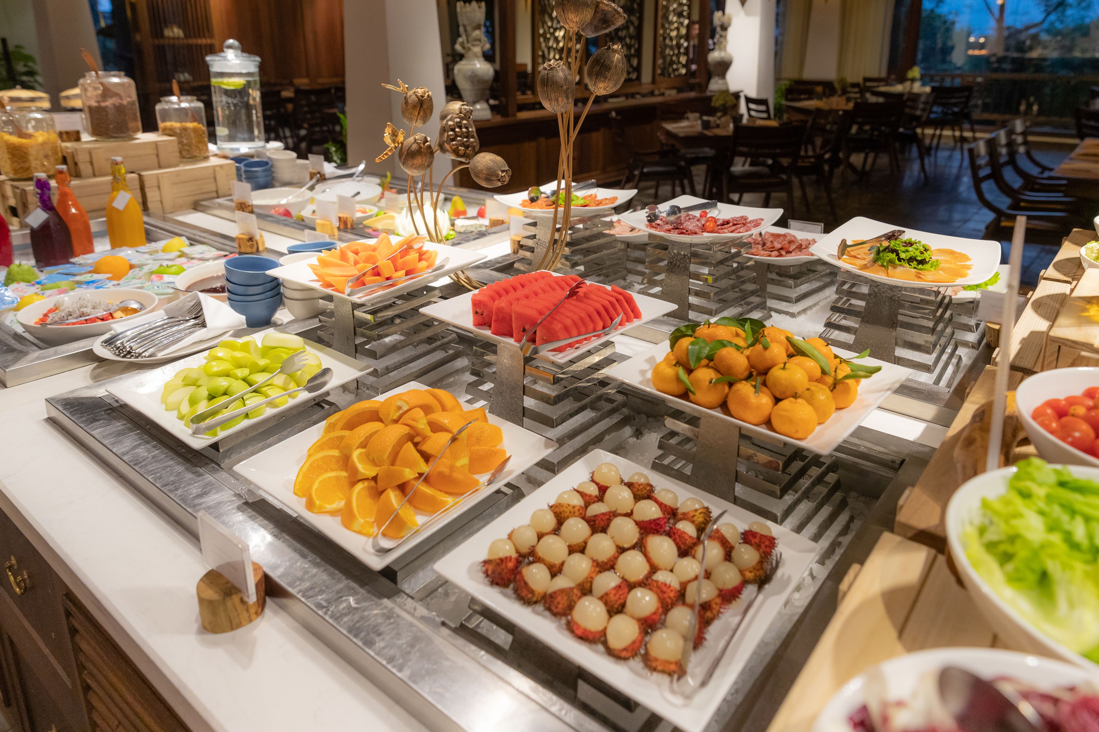 Un bufé con diversas frutas y platos.