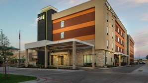 A hotel with a modern design, featuring a covered entrance and multiple floors. - Home2 Suites by Hilton Fort Collins (Fort Collins)