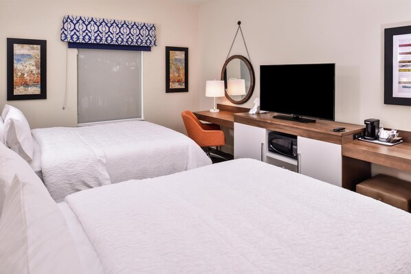 A hotel room with two beds, a desk with a computer, a TV, and a coffee maker. - Hampton Inn Benson (Benson)