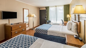 A hotel room with two beds, a TV, a desk, and a chair. - Smart Extended Stay (Beckley)
