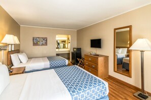 A hotel room with two beds, a desk, a dresser, a television, and a mirror. - Smart Extended Stay (Beckley)