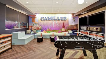 Relax and socialize in this inviting space, featuring a foosball table and comfortable seating.