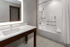 A modern bathroom with a large mirror, two sinks, a bathtub, and a shower area. - Hampton Inn Nashville Airport Century Place, TN (Nashville)